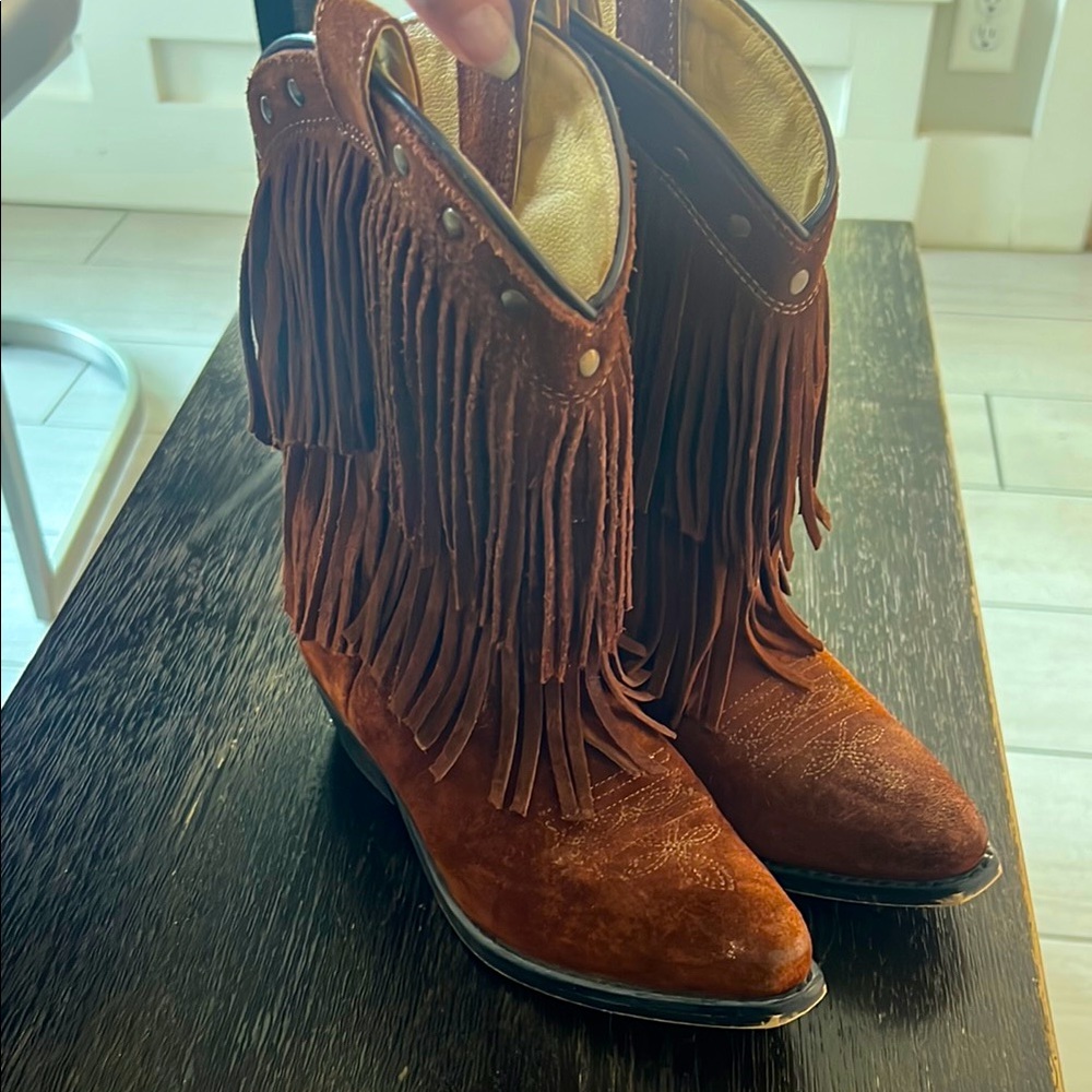 Brown suede cowboy boots didn’t wore then much